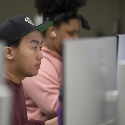 male student at a computer in CJ classroom 